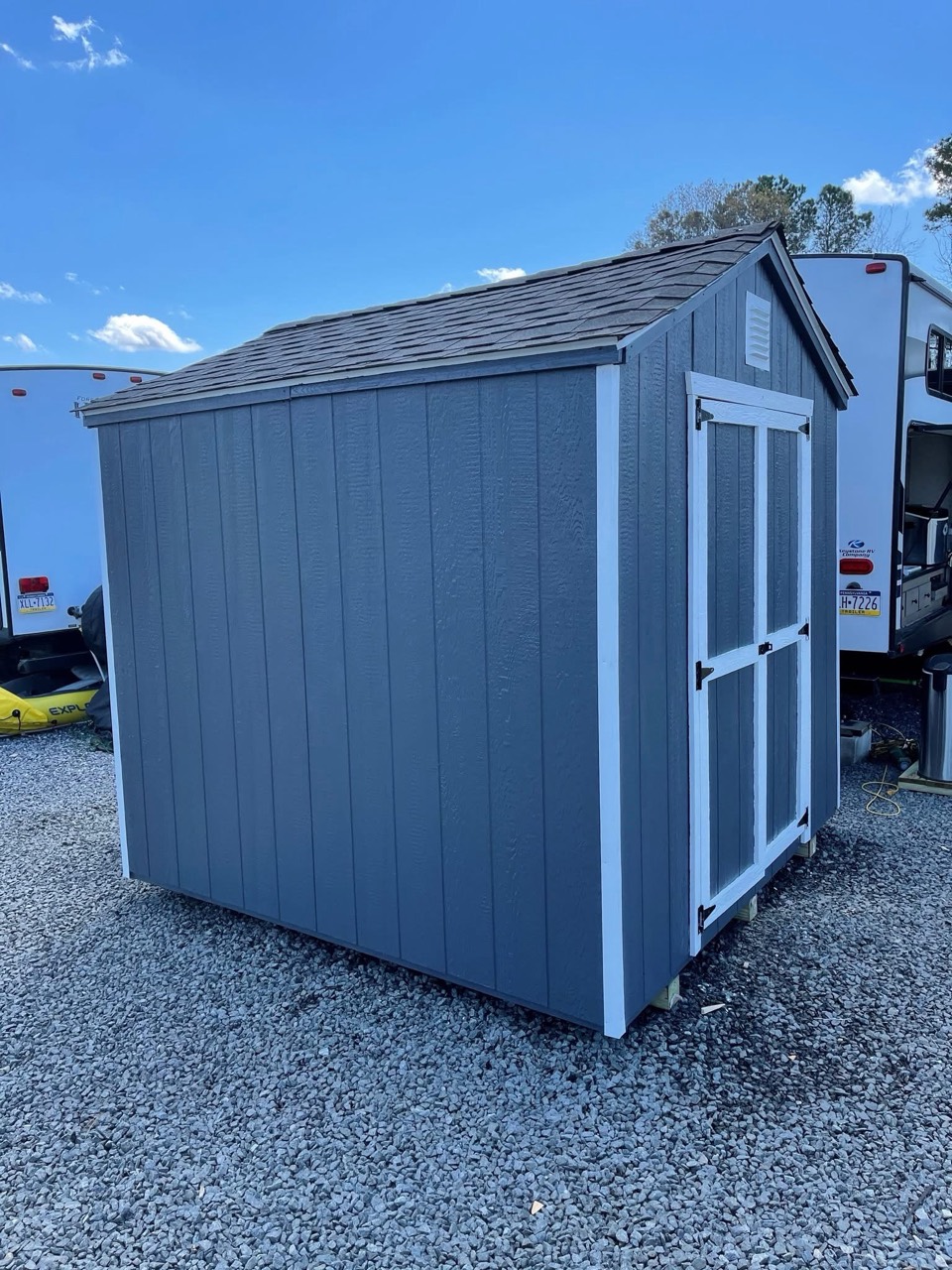 Included blue storage shed with white trim